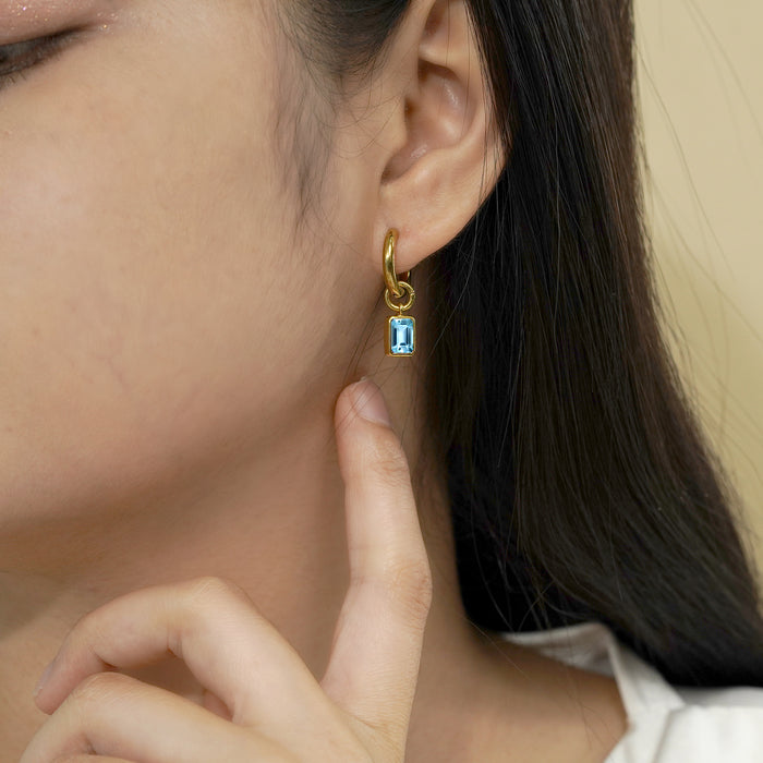 シルバー/K18YGP 1.0ct. エメラルドカット フクリン留め ハギーフープ 美麗な12月の誕生石ブルートパーズピアス